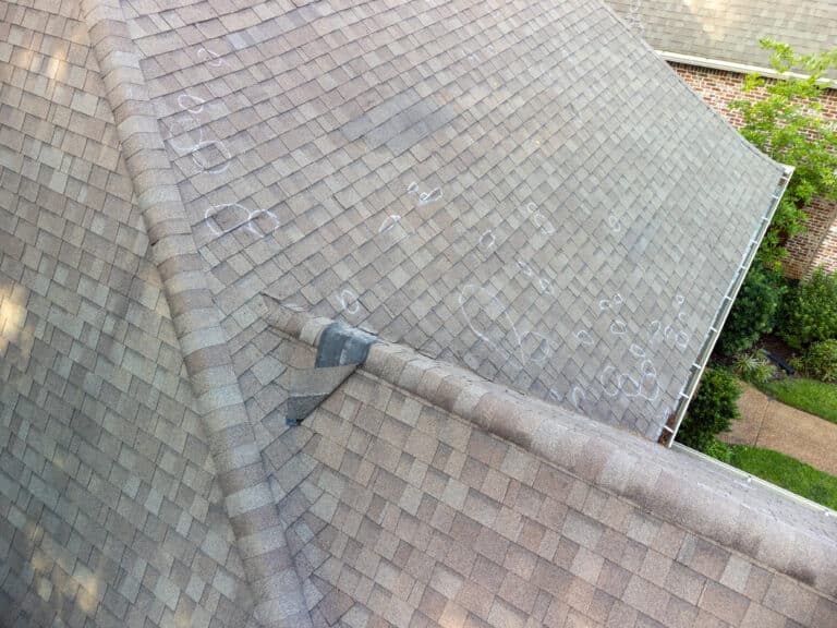 Roof with hail damage and markings from inspection